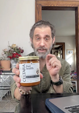 Man holding a jar of Celtara liver health supplement against a neutral background.